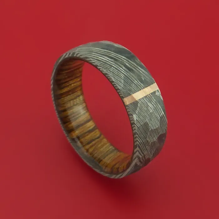 Rings Hammered Damascus Steel Ring with 14k Rose Gold Inlay and Interior Hardwood Sleeve Custom Made Band Lashbrook Rings Hammered Damascus Steel Ring with 14k Rose Gold Inlay and Interior Hardwood Sleeve Custom Made Band Lashbrook