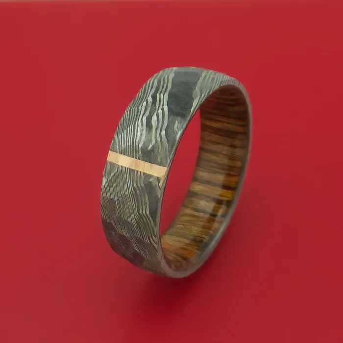 Rings Hammered Damascus Steel Ring with 14k Rose Gold Inlay and Interior Hardwood Sleeve Custom Made Band Lashbrook Rings Hammered Damascus Steel Ring with 14k Rose Gold Inlay and Interior Hardwood Sleeve Custom Made Band Lashbrook