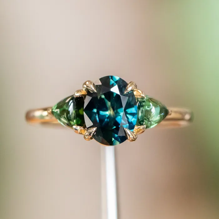 Rings 163ct Oval African Teal Blue Sapphire and Tourmaline Cabochon Trillion Three Stone Ring in 14K Yellow Gold Discovery Gems