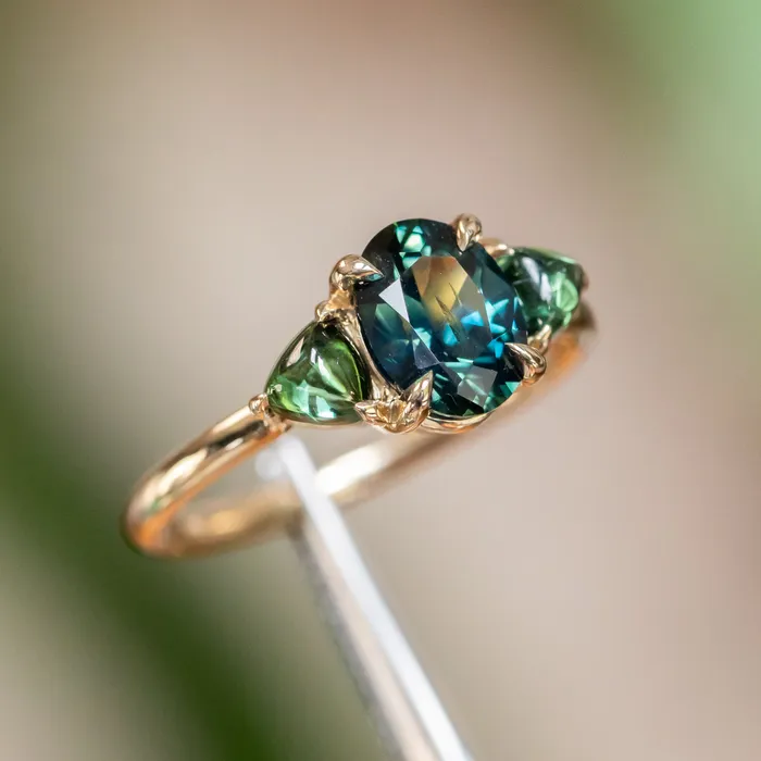 Rings 163ct Oval African Teal Blue Sapphire and Tourmaline Cabochon Trillion Three Stone Ring in 14K Yellow Gold Discovery Gems